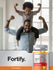 Man with child on shoulders next to a bottle of Fortify vitamin gummies