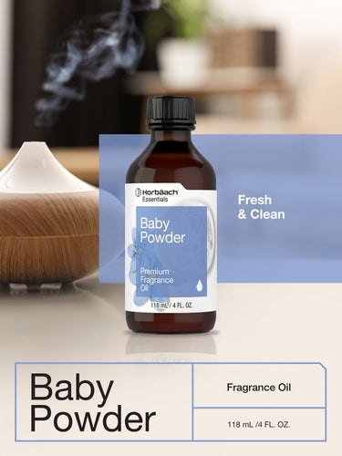 View 6 Bottle of HertaLich Naturals Baby Powder fragrance oil on a surface with a blurred background