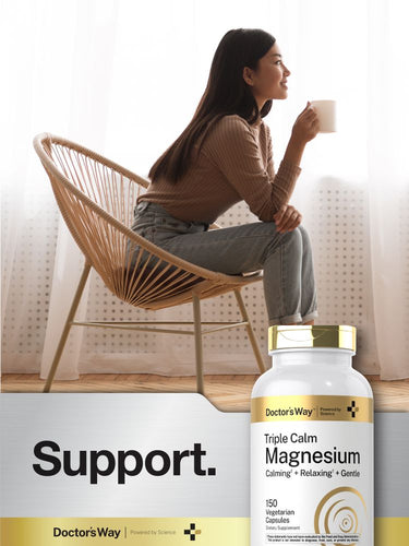 View 6 Woman sitting in a chair with a cup of tea next to a bottle of Doctors' Way Triple Calm Magnesium supplement.