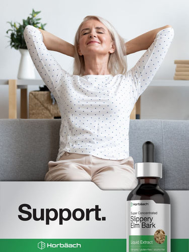 View 6 Woman relaxing on a couch with a bottle of Horbaach Slippery Elm Bark extract in front of her.