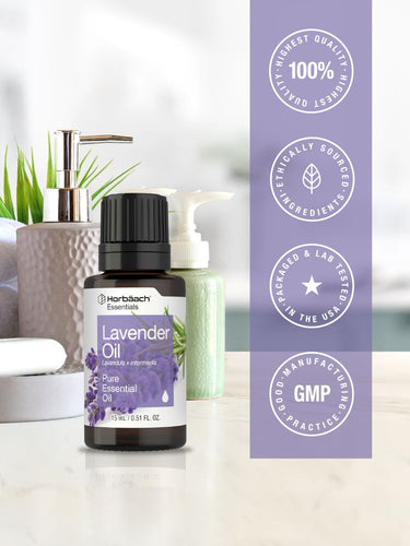 Bottle of lavender essential oil with certification logos on a white background.