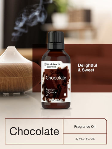 View 6 Bottle of chocolate fragrance oil with a diffuser on a table.