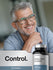 Man with glasses smiling with a bottle of amino acid complex in front.