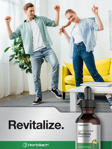 Two people dancing in a living room with a bottle of Horbaach Revitalize supplement in the foreground.