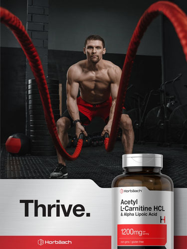 View 6 Muscular man exercising with resistance ropes and a bottle of Acetyl L-Carnitine HCL and Alpha Lipoic Acid supplement.