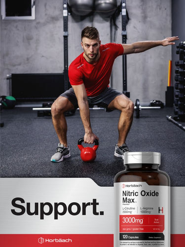 Man lifting a kettlebell in a gym with a supplement bottle labeled 'Nitric Oxide Max' in the foreground.