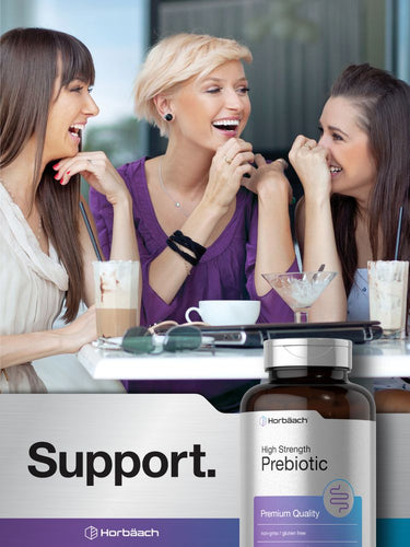 View 6 Three women laughing together with a bottle of high strength prebiotic supplement in the foreground.