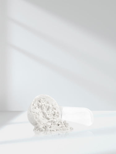 White powder in a transparent container on a white background