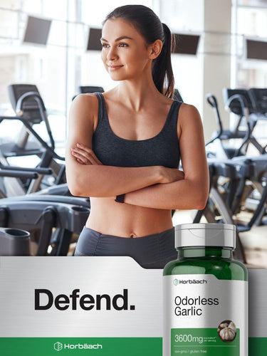 Woman in a gym setting with a bottle of Horbaach Odorless Garlic supplement.