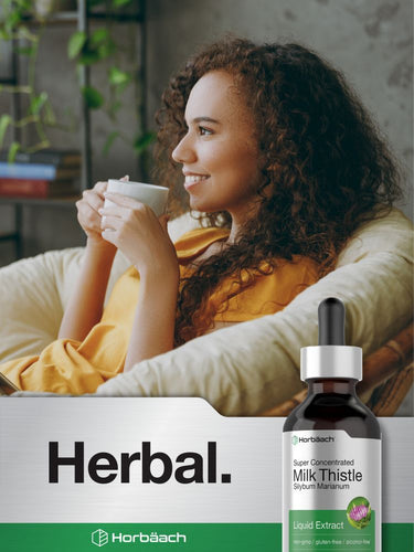 View 7 Woman holding a cup with a bottle of Horbaach Milk Thistle extract on a white background