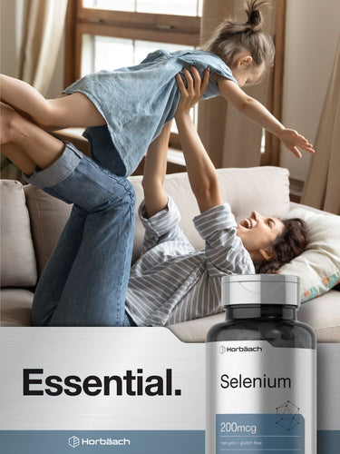 Woman and child playing on a couch with a bottle of selenium supplement in the foreground.