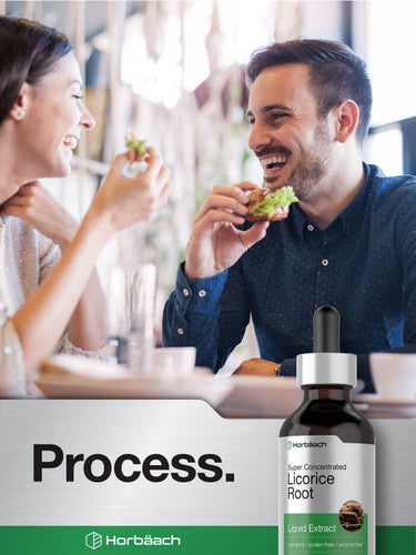 View 7 Two people enjoying food at a table with a bottle of Horbaach licorice root extract in the foreground.