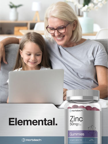 Woman and child using a laptop with a bottle of Zinc gummies in the foreground.
