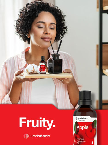Woman holding a tray with fragrance bottles and an apple, against a red background with 'Fruity' text.