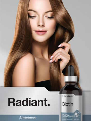 View 7 Woman with long, healthy hair and a bottle of biotin supplement on a gray background.