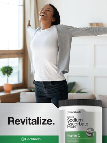 Woman standing in a bright room with a supplement container labeled 'Revitalize' and 'Horbaach'.