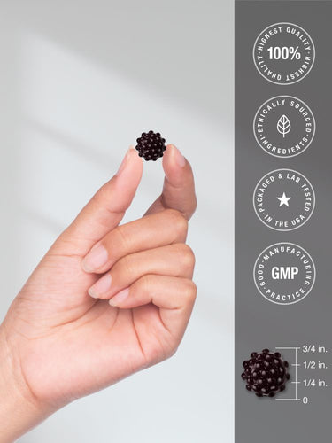 View 7 A dark, spiky gummy is held in a hand, shown with a scale indicating it is 3/4 inch tall.