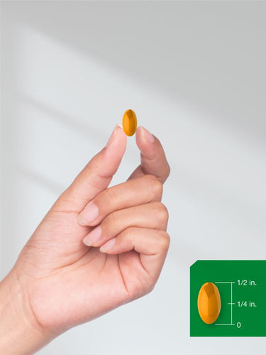View 7 Hand holding a yellow pill with a size reference on a white background