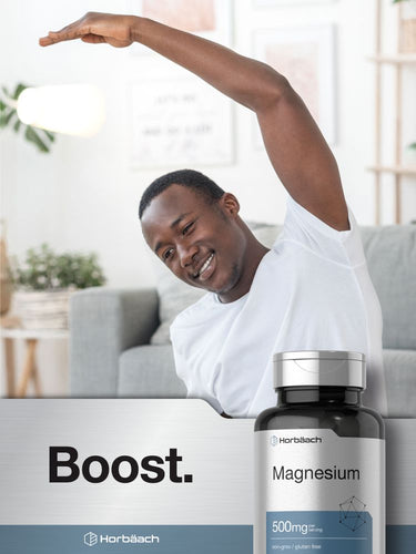View 7 Man stretching in a living room with a bottle of magnesium supplement in the foreground.