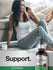 view 7 Woman sitting on a couch with a bottle of Horbaach white willow bark liquid extract.