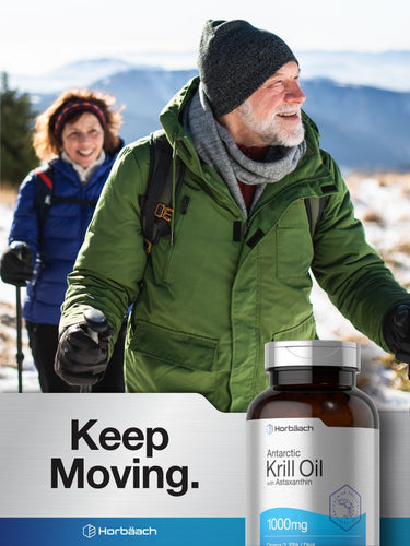 View 10 Two people hiking in a snowy landscape with Antarctic Krill Oil bottles displayed.