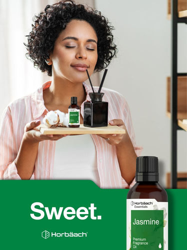 Woman holding a tray with diffusers and bottles, with Horbaach Jasmine product in the foreground.