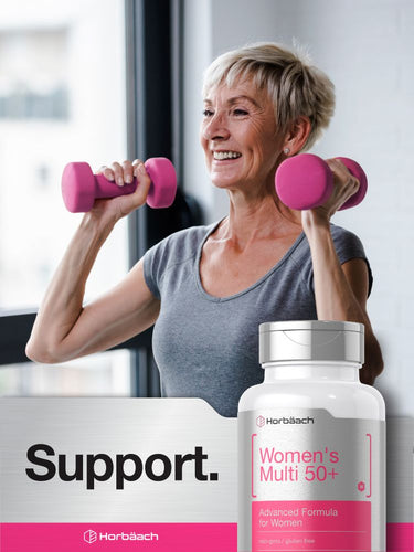 Woman exercising with pink dumbbells and a bottle of Women's Multi 50+ supplement.