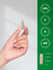 Hand holding a capsule with product details on a green background