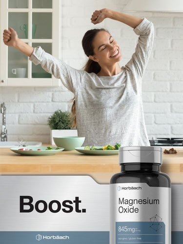 View 7 Woman stretching in a kitchen with a bottle of Horbaach Magnesium Oxide supplement in the foreground.