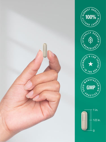 Hand holding a supplement capsule with product features on a green background