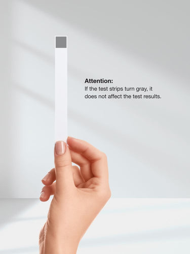 View 7 Hand holding a white test strip with text warning about gray test strips.