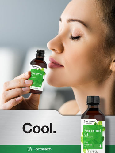 Woman holding a bottle of peppermint oil with a close-up of the oil bottle on a gray background.