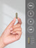 view 7 Hand holding a gold capsule with certification icons and measurements.