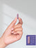 view 7 Hand holding a purple capsule with size measurement details on a white background.