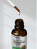 Brown bottle labeled 'Super Concentrated Ashwagandha' with dropper dispensing liquid.