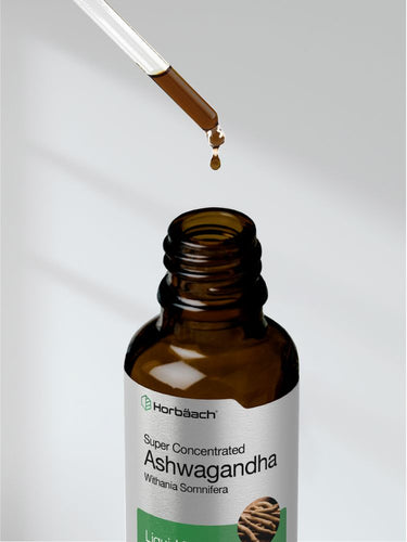 Brown bottle labeled 'Super Concentrated Ashwagandha' with dropper dispensing liquid.