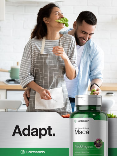 Man and woman in kitchen with Maca supplement bottle