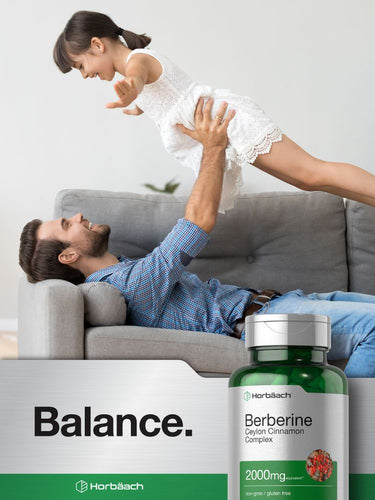 View 7 Man lying on a couch with a child, and a bottle of Herbäsch Berberine supplement in the foreground.