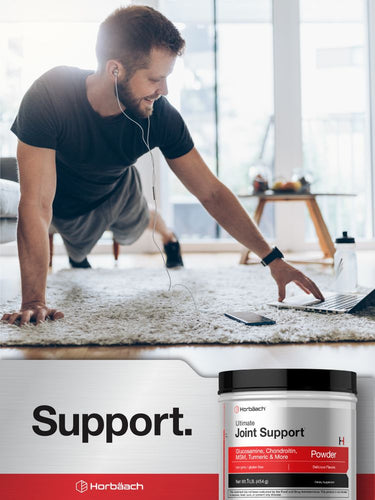 View 7 Man exercising at home with a supplement container labeled 'Ultimate Joint Support' in the foreground.