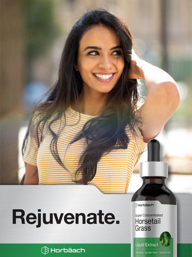 View 7 Woman with long hair smiling outdoors, Horbaach Rejuvenate bottle and box in foreground