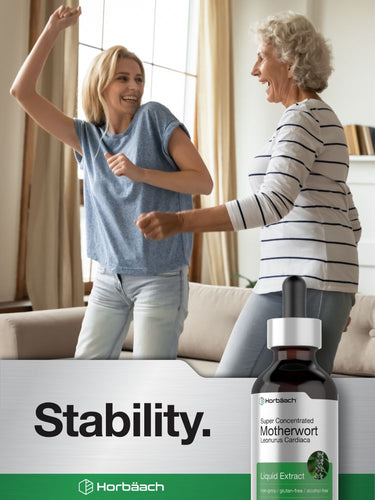 Two women interacting in a living room with a bottle of Horbaach Motherwort Liquid Extract in the foreground.