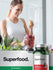 Woman preparing a smoothie with beet root superfood supplement in the foreground