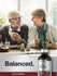 Two people sitting at a table with a bottle of Horbaach Nascent Iodine in the foreground.
