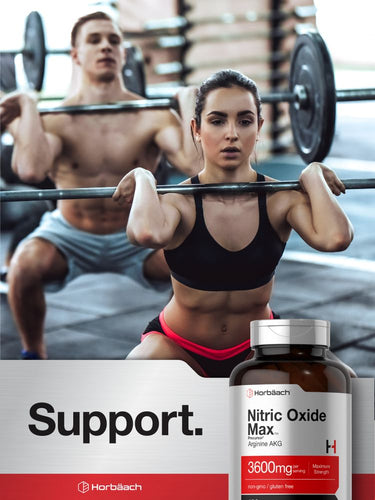 View 7 Woman lifting weights with a man in the background, bottle of Nitric Oxide Max supplement in the foreground.