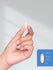 Hand holding a pill with size measurement illustration on a white background.