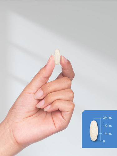 View 7 Hand holding a pill with size measurement illustration on a white background.