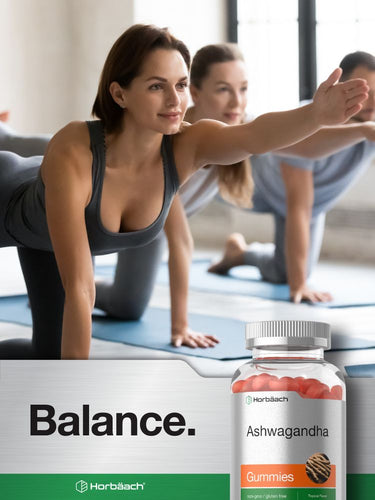 View 7 People doing yoga with a bottle of Ashwagandha gummies in the foreground.