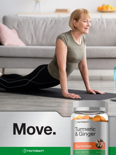 View 7 Woman doing yoga in a living room with a bottle of gummies in the foreground.