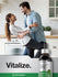 Couple embracing in a kitchen with a bottle of supplement labeled 'Vitalize'.