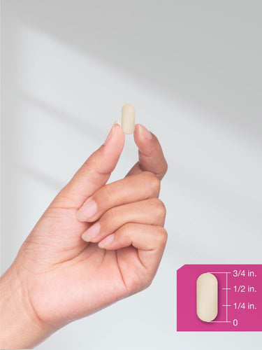 Hand holding a pill with size measurement guide on a white background